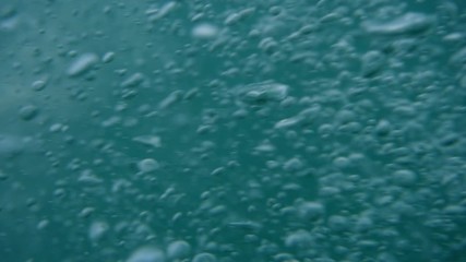 Bubbles rising to the surface. Air bubbles in water in sea (underwater shot), good for backgrounds. Slow motion.