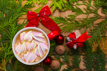 Fototapeta na wymiar coffee with marshmallows in the red cup. Christmas and new year mood