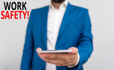 Word writing text Work Safety. Business photo showcasing policies and procedures in place to ensure health of employees Business concept with man holding mobile phone with touch screen