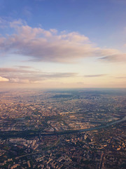 Aerial cityscape view from a plane over St Denis district and Seine river in Paris, France.