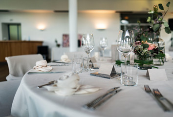 Closeup of decorated wedding tables, with flowers serviette and cutlery