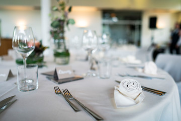 Closeup of decorated wedding tables, with flowers serviette and cutlery
