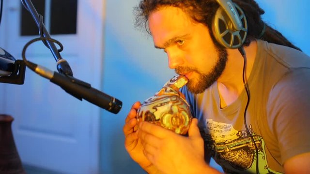 portrait composer playing a wind instrument