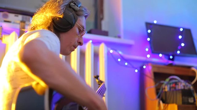 close-up composer plays the guitar, improvisation