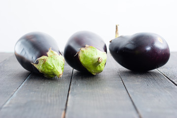 eggplants on black wood table background