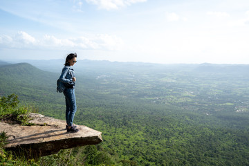 A woman backpacker standing on rock