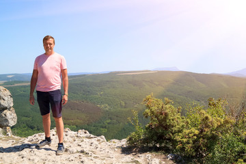 brutal man on top of a mountain