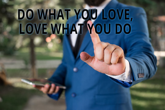 Word writing text Do What You Love Love What You Do. Business photo showcasing Pursue your dreams or passions in life Businessman with pointing finger in front of him