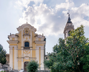 Naklejka premium The facade of the beautiful Church of the Holy Martyrs or San Graziano in Arona, Italy, against a picturesque sky