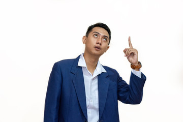Fototapeta na wymiar young asian Businessman pointing up on copy space