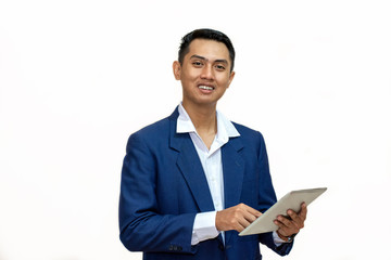 Portrait of a young asian businessman using tablet computer