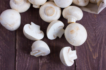 Champignon mushrooms in a bag on a dark background
