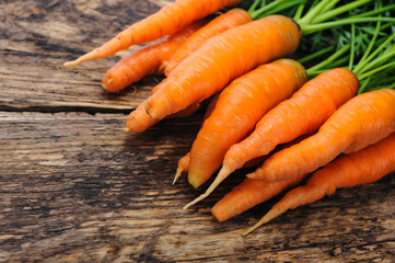 Bunch of fresh organic carrots on a wooden rustic table