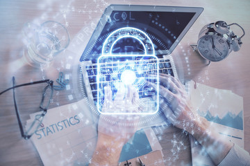 Double exposure of lock icon with man working on computer on background. Concept of network security.