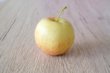 close up red apple isolated on wood background