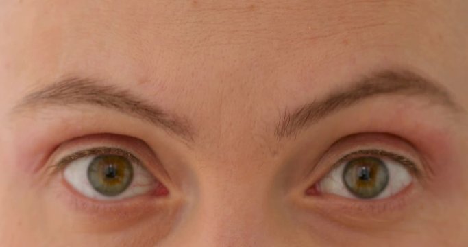 Young woman moves her eyebrows close up