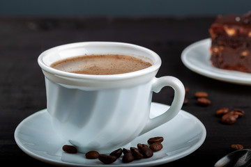 Cup of coffee on a black wooden table