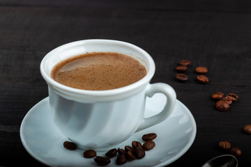Cup of coffee on a black wooden table