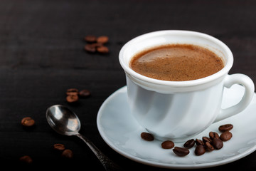 Cup of coffee on a black wooden table