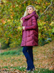 Puffer fashion concept. Professional stylist advice. Girl fashionable blonde walk in autumn park. Woman wear warm jacket. Jackets everyone should have. Best puffer coat to buy. How pick puffer jacket