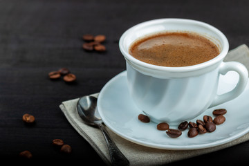 Cup of coffee on a black wooden table
