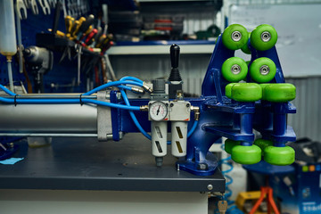 A modern technological machine for bending parts in a car service. Close-up.