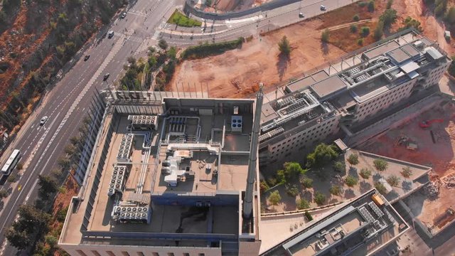 Top building with large antena , Jerusalem Mount Hotzvim Aerial Drone footage over Large building in Hi tech Park Jerusalem Israel