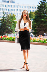 Business brunette woman in summer street