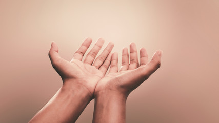 Praying hands with faith in religion and belief in God on calm background. Power of hope or love...