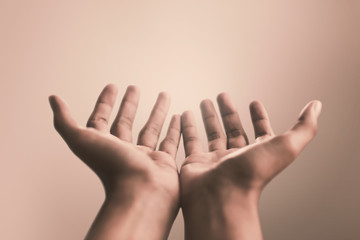 Praying hands with faith in religion and belief in God on calm background. Power of hope or love...