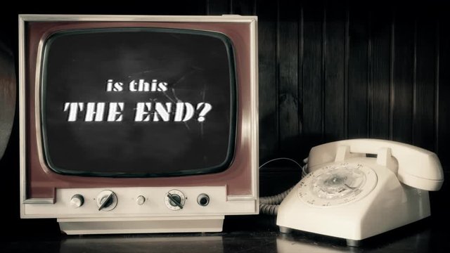 Analog scene with a rotary phone and a vintage TV: an end title as seen in old horror movies, asking Is this The End?. Broken glass.