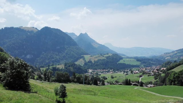 Swiss countryside aerial shot. Camera flying over the fields on a sunny afternoon