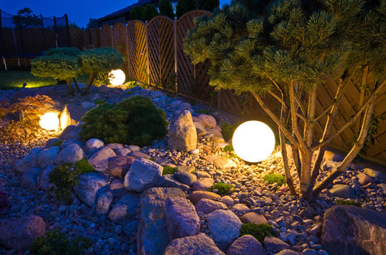 Home Garden At Night, Illuminated By Globe Shaped Lights