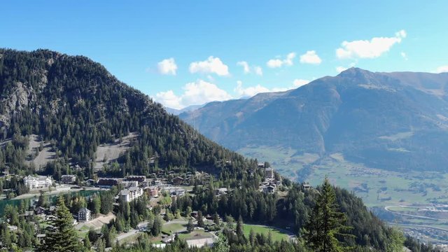 Swiss alps Mountain forest - camera rising through the trees aerial shot. Discovering a breathtaking view on the valley