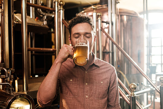 Man tasting fresh beer in a brewery