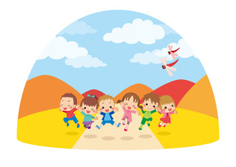 Obraz na płótnie Canvas 秋の日に草原でジャンプする元気な子供たち【ドーム型】