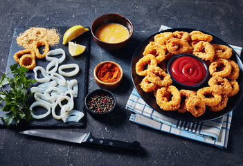 crispy calamari rings on a black plate