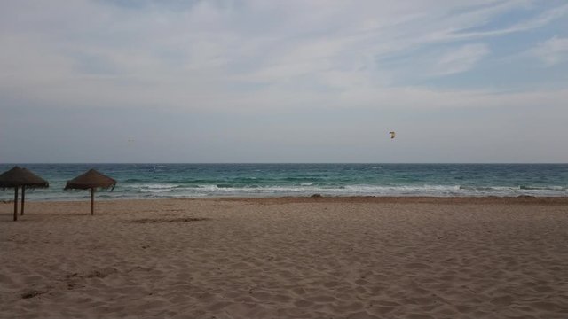 Kiteboarding on mediterranean sea at Calpe beach on a cool spinrg afternoon