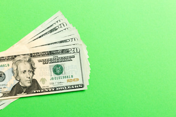 Stack of 20 dollar banknotes on colorful background. Top view of financial concept with empty space for your design