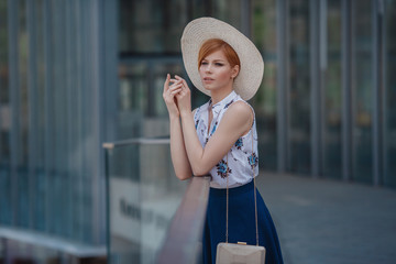 Young attractive cheerful woman walking in city.