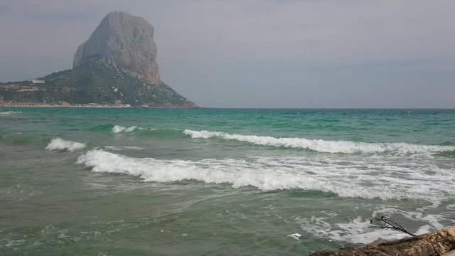 Stunning view of Penyal d'Ifac and mediterranean sea waves on a calm spring evening