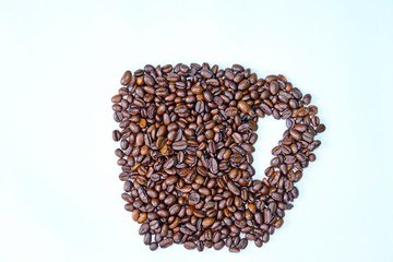 Roasted coffee beans arranged in cup shape isolate on white background.