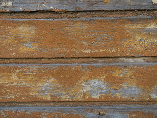 Fototapeta na wymiar weathered wooden background, peeling paint, nailed boarded fence,