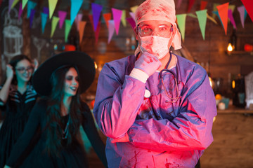 Portrait of suprised man dressed up like a doctor for halloween celebration