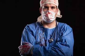Portrait man in doctor costume for halloween with blood on his hands