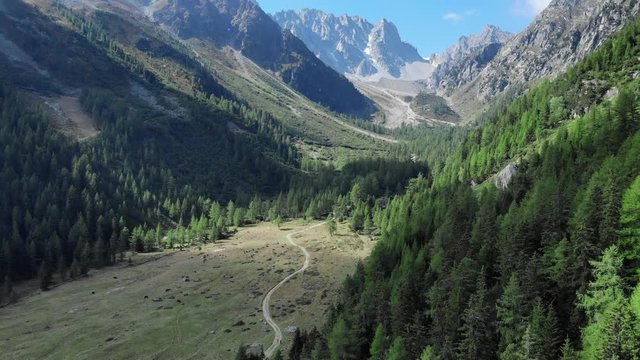Scenic mountain panorama in the Swiss alps aerial shot. 4K Drone shot with early morning light