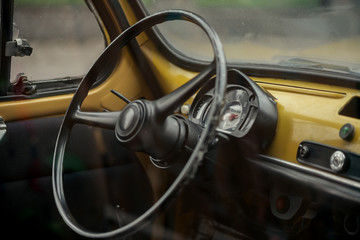 control panel of old yellow car 