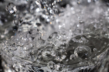 Clear water bubbles floating in transparent glass, Close up & Macro shot, Selective focus, Healthy Drink concept