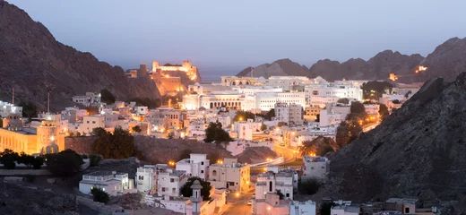 Foto op Plexiglas Old Muscat buildings after sunset with a view over Al Jalai Fort, middle east, Oman. © Chris
