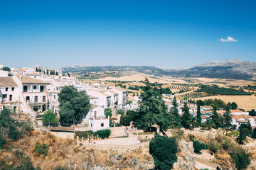 Beautiful cosy old white houses with mountains in the background in Ronda, Andalusia, Spain